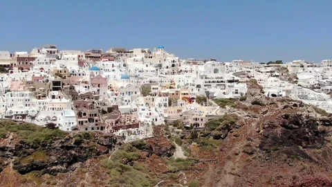 Flight around of Three Blue Domes church in Oia town on Santorini island, Greece Stock Footage 121261797