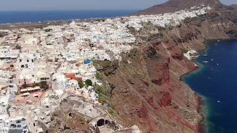 Flight around of Three Blue Domes church in Oia town on Santorini island, Greece Stock Footage 121442701