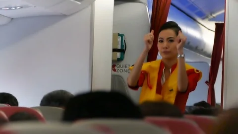 Flight attendant in airplane explains rules about safety during take off Stock Footage 80017086
