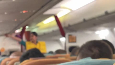 A flight attendant conducts a pre-flight briefing. Blur video. Stock Footage 319404873