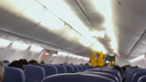 A flight attendant conducts a pre-flight briefing. Stock Footage 320810790