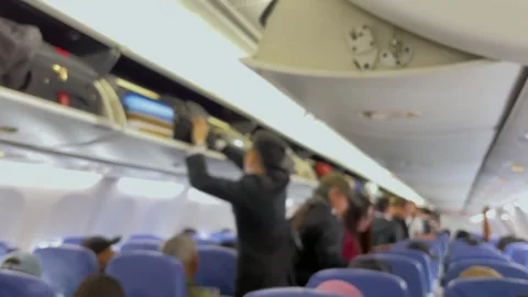 The flight attendant is helping passengers. Stock Footage 320810797