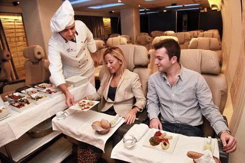Flight attendants, before flight, proofing services to passengers Stock Photos