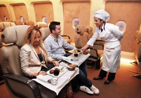 Flight attendants, before flight, proofing services to passengers Stock Photos