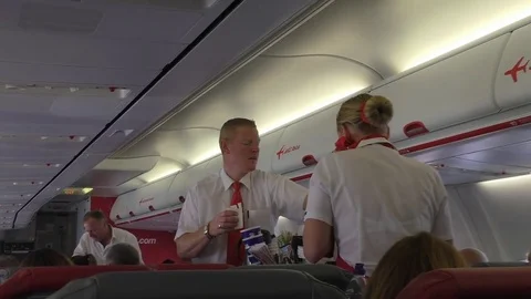 Flight attendants serving drinks Stock Footage 83874567