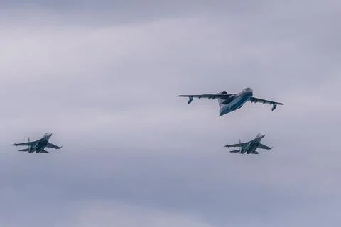 A flight of Be-200 and Su-27P aircraft at the naval parade. Stock Photos