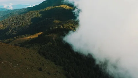 The flight in beautiful clouds above mountain forest Stock Footage 116057579