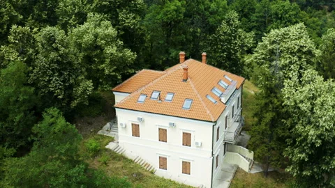 Flight by a beautiful house in a thick forest Stock Footage 135839770