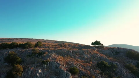 Flight from behind a crest of a cliff overlooking the bay. Dokos Island, Greece. Stock Footage 131014565