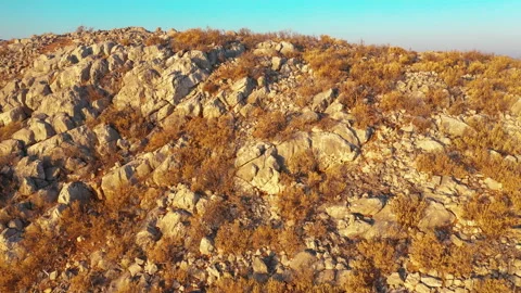 Flight from behind a crest of a cliff overlooking the bay. Dokos Island, Greece. Stock Footage 131015381
