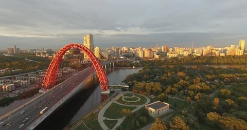 Flight beside red bridge and cityscape on sunset in autumn Video stock 107614082