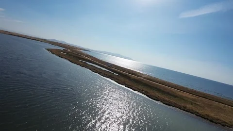 Flight between lake and sea Stock Footage 293200327