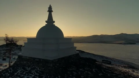 Flight Buddhist stupa of enlightenment at sunset, winter lake Baikal landmark 4k Stock Footage 165663538