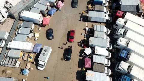 Flight of the camera above the trailers on the market Stock Footage 93449002