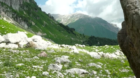 Flight of the Camera Along a Stone Against High Mountains and the Blue Sky Video stock 66277175