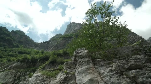 Flight of the Camera Along a Stone Against High Mountains and the Blue Sky Video stock 66277190