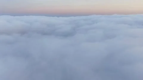 Flight of the camera over fluffy clouds on the background of the sunset horizon 스톡 동영상 144624680