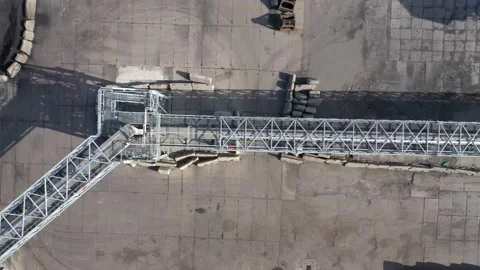 Flight of the camera over the metal gallery for the delivery of grain to the Stock Footage 157636679