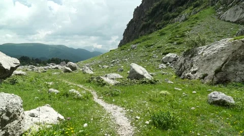 Flight of the Camera Over a Mountain Footpath in a Stones Canyon Stock-Footage 66277598