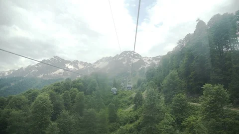 Flight of camera over mountains. Aibga Ridge. Cable car with cabins Stock Footage 96513302