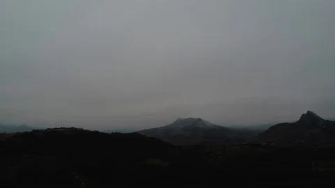 Flight of the camera over the mountains with forests in the dull autumn Stock Footage 86790791
