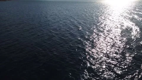 Flight of the camera over the surface of the water. Sea or ocean, faint, ligh Stock Footage 130854828
