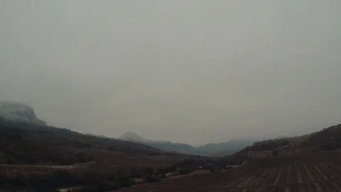 Flight of the camera over the vineyards against the backdrop of mountain peaks Stock Footage 86790778