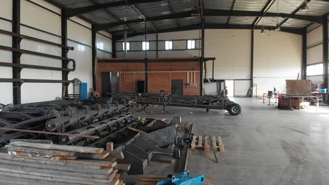 Flight of the camera through the hangar of industrial production of machinery Stock Footage 119870522