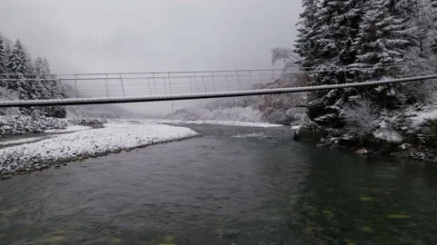 The flight of the camera under a suspension bridge over a mountain river wit Stock Footage 170728518