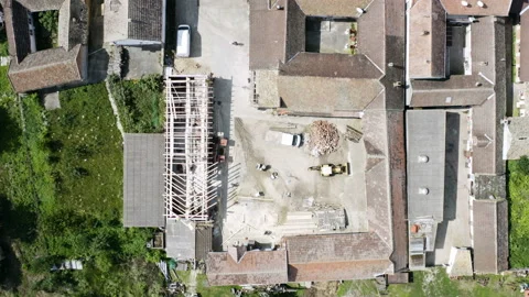 Flight with a circular motion above a constructon site of a unfinished house Видео 137025408