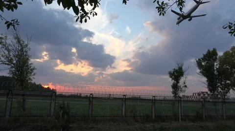Flight at close range aircraft over the green field at sunset Stock Footage 42057362