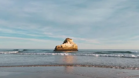 Flight close to the water towards scenic solitary rock in the ocean, Portugal Stock Footage 274683149