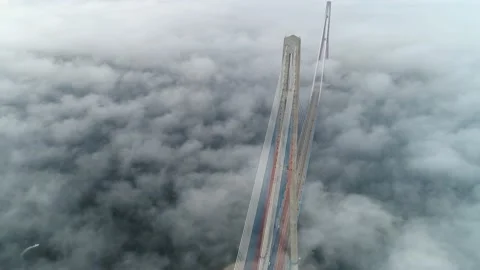 Flight clouds fog Russian cable-stayed bridge Vladivostok cityscape motion fast Stock Footage 145297640