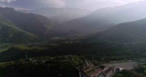 Flight in clouds over mysterious valley with monastery. 426 213246 15 Stock Footage 130519315