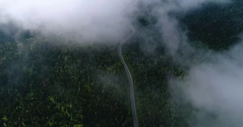Flight in the clouds. A view of the earth through the clouds. A winding mountain 스톡 동영상 77660268