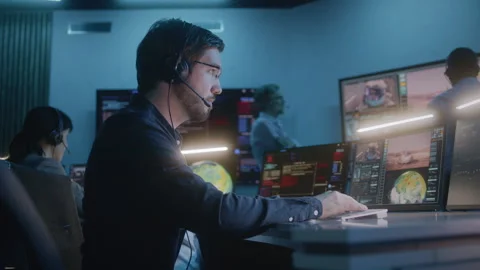Flight control employee monitors space mission, claps hands after space rocket Stock Footage 242717895