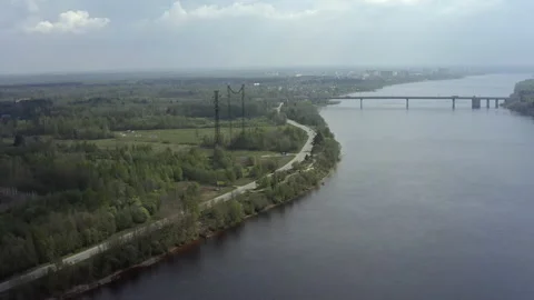 Flight of the copter over the river and the road Stock Footage 155184671