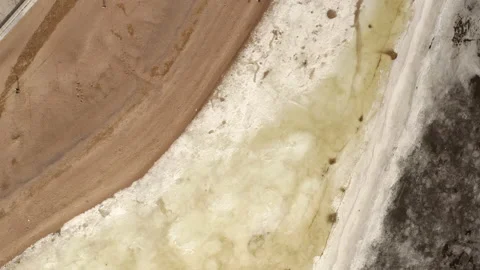 Flight of a copter over a river covered with ice and sandy shore Stock Footage 155184217