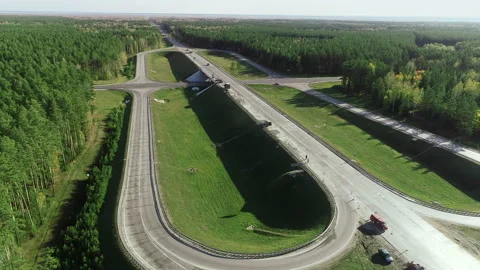 Flight of a copter over a traffic intersection with moving cars and trucks. Road Stock-Footage 139865076