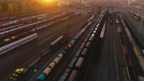 Flight of the copter through the railway sorting station at sunset. Many wagons Stock Footage 133458219