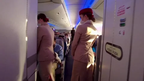 Flight crew and passengers on board flight from London Stock Footage 280219402