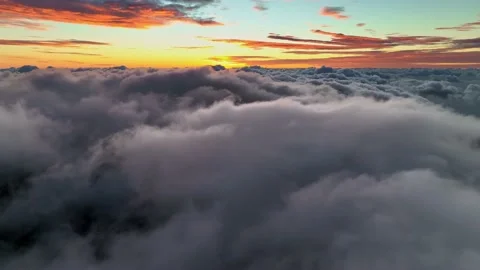Flight at dawn over dense clouds. Magnificent sunrise over the clouds. Aerial Video stock 173462279