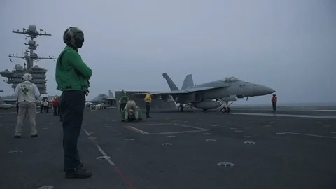 Flight deck crew and F/A-18 Hornet aboard USS John C Stennis Stock Footage 101373819