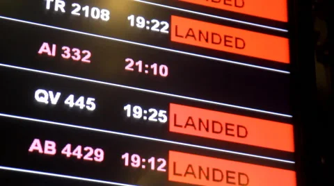 Flight delayed on information board in airport terminal, selective focus. Stock Footage