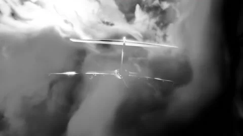 Flight. Design. Clouds of bright light smoke in which a small plane flies gently Stock Footage 221434078