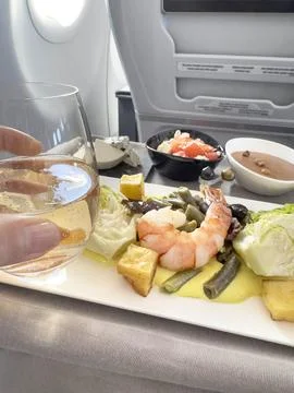 In-flight dining experience in business class cabin Stock Photos