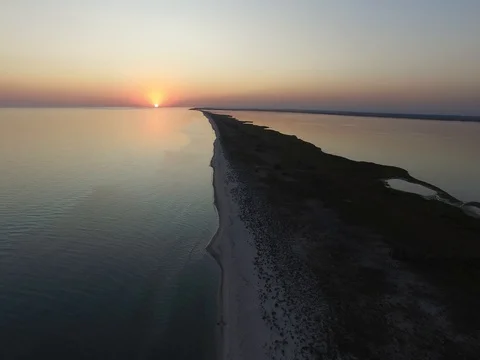 Flight down over the sea coast during sunset Video stock 80296877