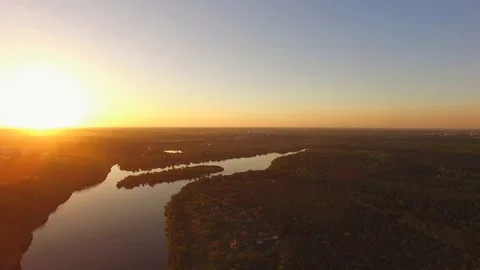 Flight down over the wooded coast of a large river next to a large city Video stock 89380746