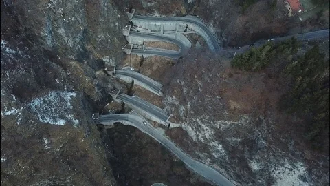 Flight down towards San Boldo pass serpentine road in Italy Stock Footage 113825952