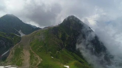 Flight dramatic clouds fog high peaks dark mountains Ski slope elevator Sochi Stock Footage 122630193